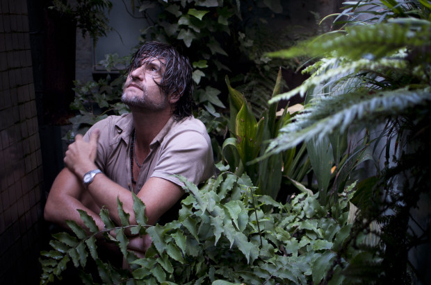 John, photographed in the verdant grotto he has created in his basement.